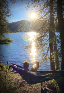 Enjoying the sunset in a hammock near an alpine lake